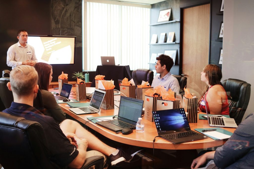 Team members discussing governance and compliance in a meeting room