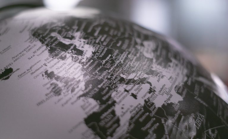 Grayscale desk globe representing global risk