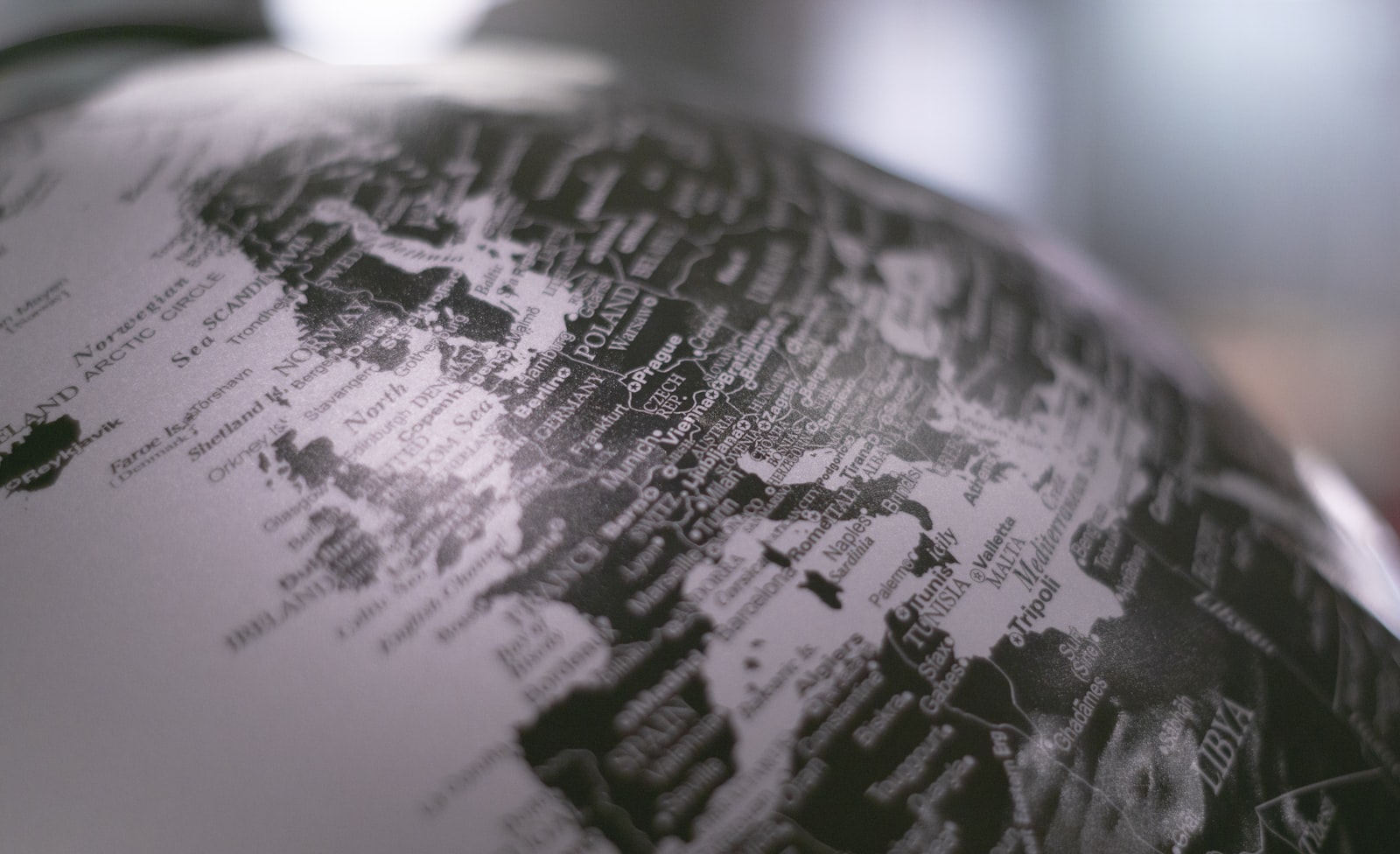 Grayscale desk globe representing global risk