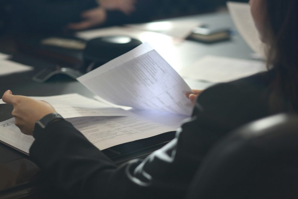 Consultant reviewing documents during an advisory session